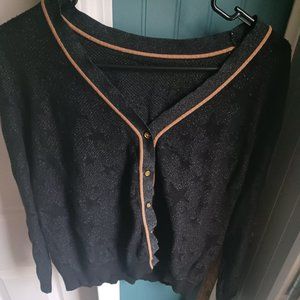black cardigan with transparent star print & rust-colored piping